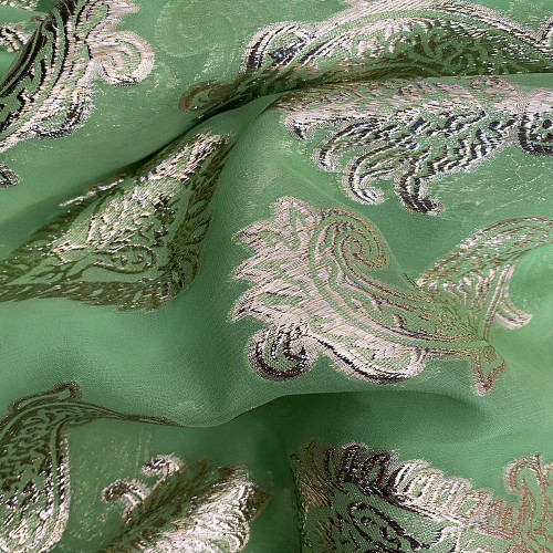 Gold metallic silk jacquard on anise green chiffon background