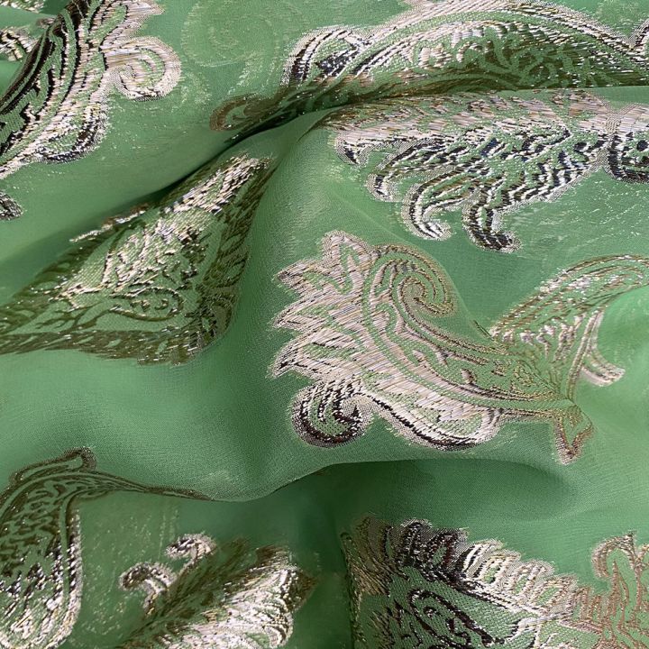 Gold metallic silk jacquard on anise green chiffon background