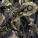 Calais lace gold laminette on a black background