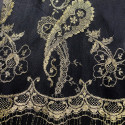 Calais lace gold laminette on a black background