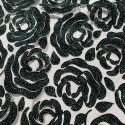 Sequined tulle with flocked flowers and emerald green glitter on black tulle