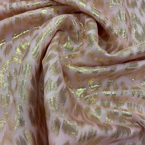 Gold metallic silk jacquard fabric on pink chiffon background