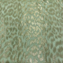 Gold metallic silk jacquard fabric on pale green chiffon background