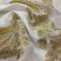 Metallic silk jacquard flowers on a gold ivory muslin background Metallic silk jacquard flowers on a gold ivory muslin background