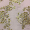 Metallic silk jacquard flowers on a gold old pink muslin background Metallic silk jacquard flowers on a gold old pink muslin background