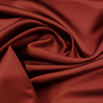 Double sided rust orange/black duchess satin fabric