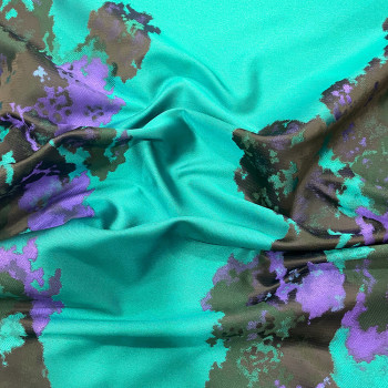 Jacquard fabric with purple abstract pattern on a turquoise background
