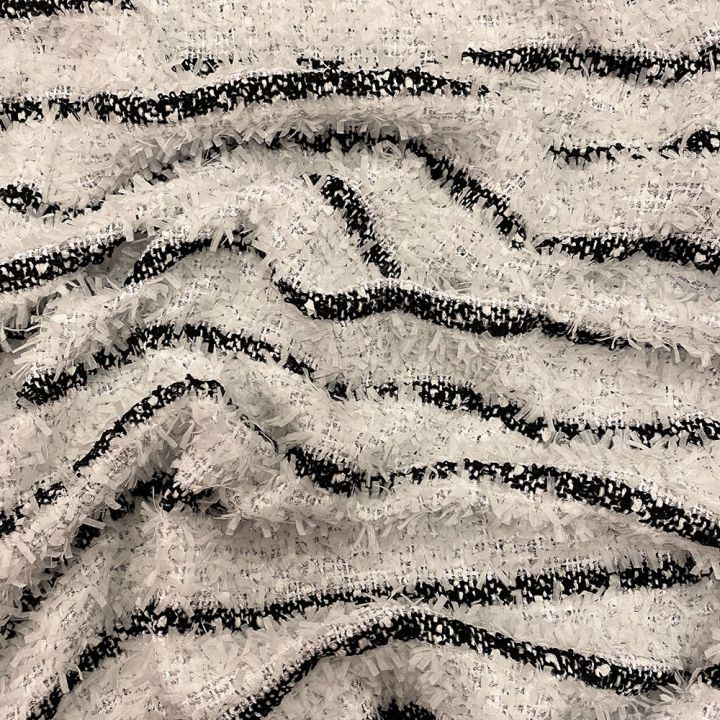 Woven and iridescent fabric with black and white stripes