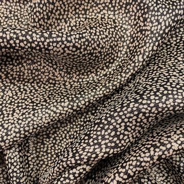 Silk lamé fabric with polka dots on a black background
