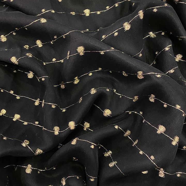 Jacquard silk fabric with cut gold bubbles on black voile