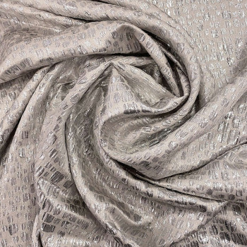 Silver scale silk lamé fabric on a beige background