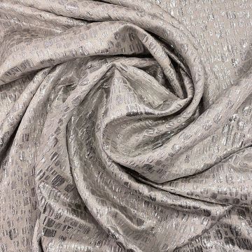 Silver scale silk lamé fabric on a beige background