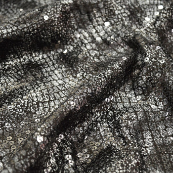 Tissu paillettes argent sur fond noir imprimé crocodile