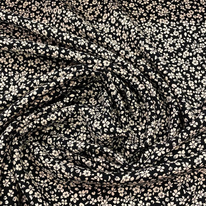 Tissu twill 100% viscose imprimé floral blanc cassé sur fond noir